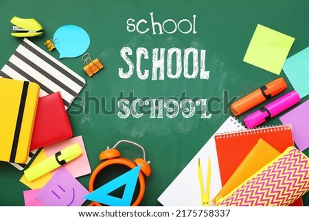 Set of stationery and words SCHOOL on blackboard