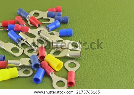 Coloured crimp terminals for different wire sizes. Copper sleeves for crimping electrical cables. Ferrules. Selective focus, copy space Royalty-Free Stock Photo #2175765165