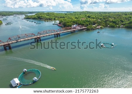 Aerial of the Anda Bridge connecting the island with the mainland and Bolinao. Crossing the Kakiputan Channel, which is dotted with several fish pens. Royalty-Free Stock Photo #2175772263