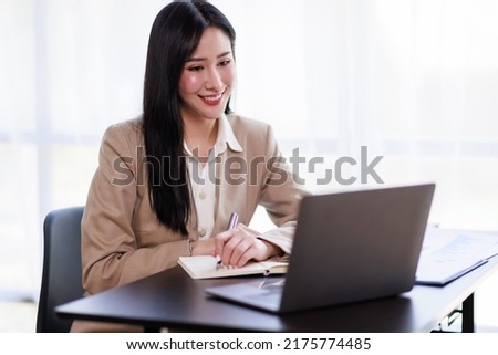 Asian Businesswoman working on laptop at the office with documents on his desk, doing planning analyzing the financial report, business plan investment, finance analysis concept