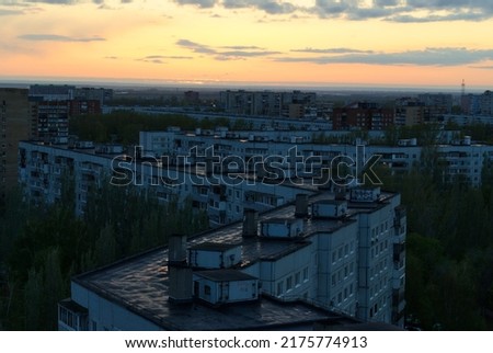 Panorama of the evening city of Togliatti from the height of the 16th floor against the background of the sunset sky.