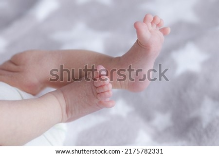 legs of a lying baby . High quality photo