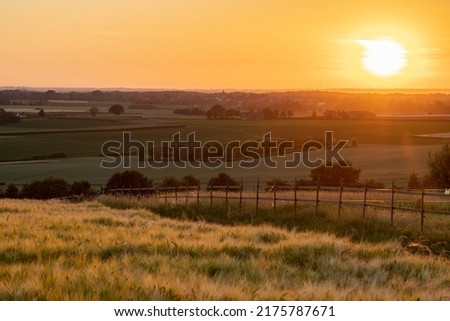A golden sunset over the rolling hills of south Limburg in the Netherlands creating holiday vibes. The views and the warm glow over the landscape create a feeling of being in the Mediterranean.