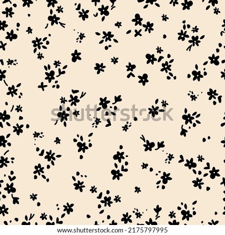 Simple vintage pattern. Small black flowers, leaves and dots. Light beige background. Fashionable print for textiles and wallpaper.