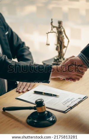 business people shake hands to make an agreement male judge legal advisor A court litigation planning service contract after co-operation and consultation between a male lawyer and a business client.