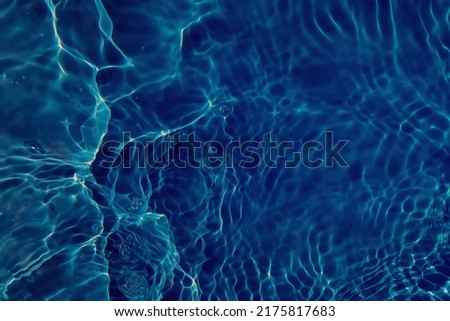 Defocus blurred blue watercolor in swimming pool rippled water detail background. Water splash, water spray background.