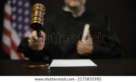 Male judge hitting gavel, calling court members to stand, United States justice system Royalty-Free Stock Photo #2175831985