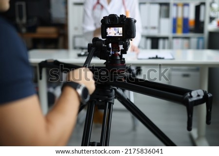 Videographer filming doctor on medical remote training Royalty-Free Stock Photo #2175836041