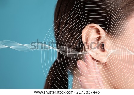 Hearing loss concept. Woman and sound waves illustration on light blue background, closeup Royalty-Free Stock Photo #2175837445