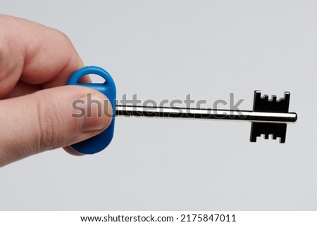 Real estate business theme. Metal apartment key in hand