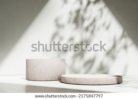 
Luxury marble table with plant shadow on white wall and stone podium for product placement display. Trendy neutral aesthetic mockup template for beauty and cosmetics scene.