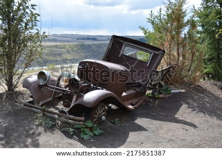 Antique roadster overlooks river valley Royalty-Free Stock Photo #2175851387
