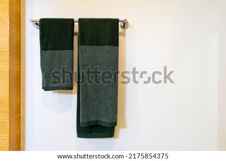 bathroom towel dryer on gray wall background with copy space