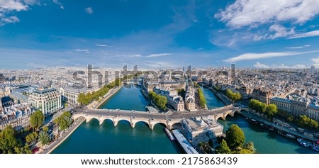 Paris aerial panorama with river Seine, Pont Neuf bridge, ile de la cite and Notre-Dame church, France. Holidays vacation destination. Panoramic view above historical Parisian buildings and landmarks. Royalty-Free Stock Photo #2175863439