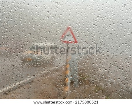 Water drops on the glass,Concept of driving in rain, bad driving conditions, selective focus.