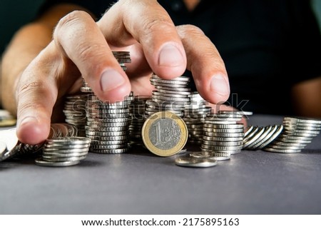 euro coin money and raking hand