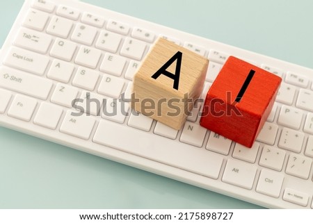 The word AI, artificial intelligence on wooden blocks and a computer keyboard, The concept of modern technological development