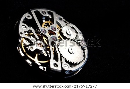 vintage mechanical watch mechanism over black background Royalty-Free Stock Photo #2175917277