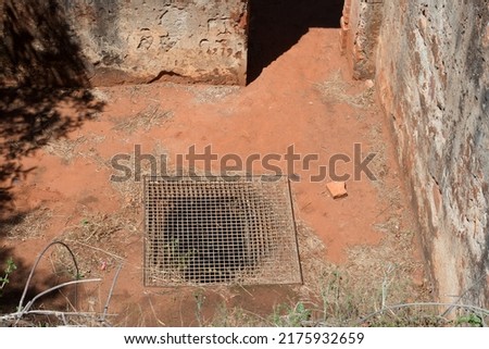 GRATING OVER AN OPENING IN THE FLOOR OF A CHAMBER IN A FORT IN RUINS