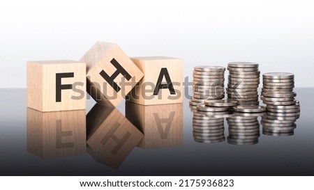 FHA - text is made up of letters on wooden cubes lying on a mirror surface