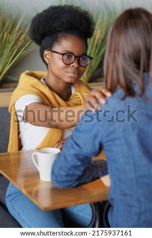 moral support and mental health, African American woman supporting a colleague in a difficult situation, words of support or help with advice, communication between patient and psychologist, spiritual Royalty-Free Stock Photo #2175937161