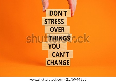 Do not stress symbol. Wooden blocks with words Do not stress over things you can not change. Beautiful orange background copy space. Businessman hand. Business motivational not stress concept.