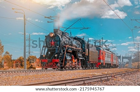 A vintage steam locomotive at dawn. Retro travel and tourism. 