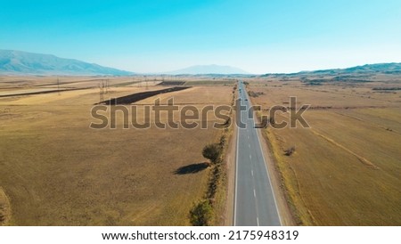 Long Highway Across Rural Fields. Road. Highway. Way. Freeway. Aerial Photo. Landscape. Cars on the Highway. Aerial Photography.