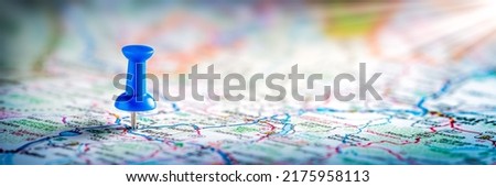 Blue Push-pin On Road Map Background - Travel Destination Concept Royalty-Free Stock Photo #2175958113