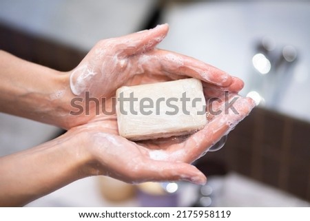 Closeup on young woman hands with soap bar Royalty-Free Stock Photo #2175958119