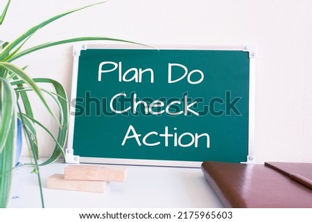 Text Plan Do Check Action written on the green chalkboard