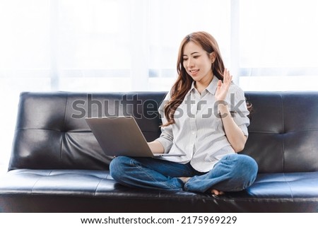 Portrait image of a beautiful asian woman using laptop computer for video call