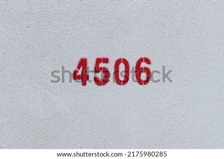 Red Number 4506 on the white wall. Spray paint.
