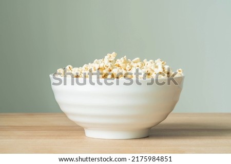 Popcorn in bowl on the wooden table