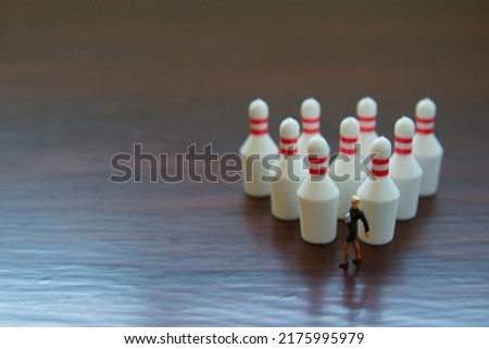 Right side photo of bowling pin and woman and wooden background