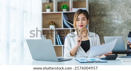 Business asian woman using laptop for do math finance on wooden desk in office, tax, accounting, financial concept 