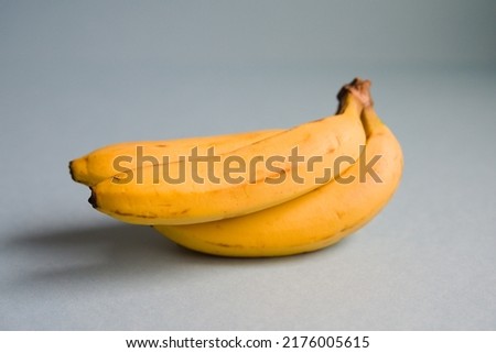Centered photo of banana and light blue background