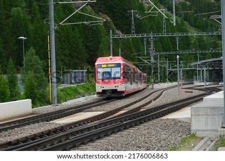 Selective focus and motion blur picture of train that been used to Zermatt moving at the railway. Train that lead to famous place called Matterhorn.