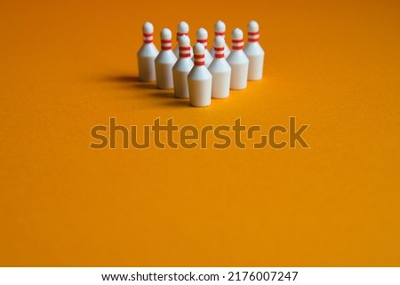 Centered photo of bowling pin and orange background