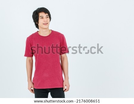 Portrait isolated cutout full body studio shot of Asian young handsome smart confident male model in street style outfit t shirt denim and sneakers standing posing look at camera on white background.