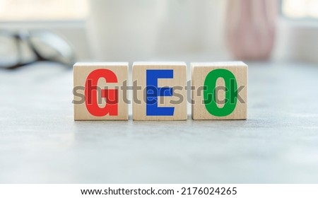 GEO. text on wood cubes. text in black letters on wood blocks.