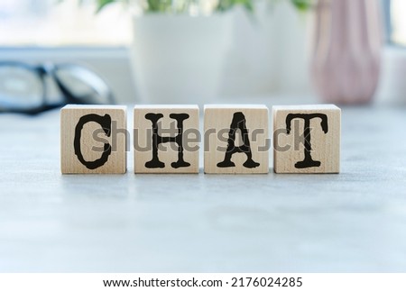 CHAT Word Written In Wooden Cube on wooden table.
