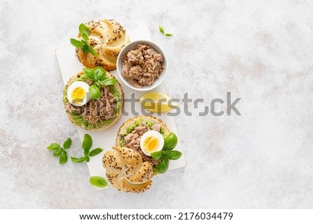 Canned tuna open sandwiches. Buns burgers with canned tuna, boiled egg and avocado Royalty-Free Stock Photo #2176034479