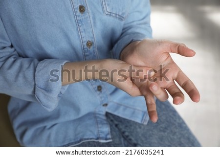 Woman suffering from trigger finger at home, closeup Royalty-Free Stock Photo #2176035241