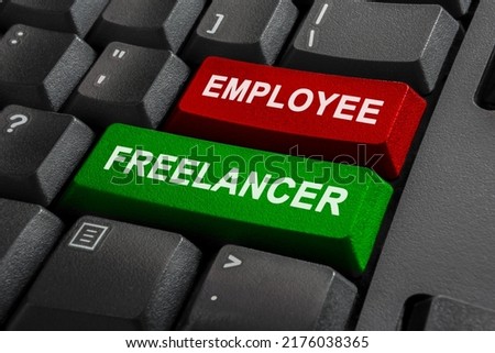 Employee or Freelancer - Keyboard with two options - decision between independent and insecure freelance or employment. Self-employment vs work under boss. High quality photo.