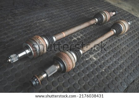 Old used Rear Drive Axles in garage shop. Royalty-Free Stock Photo #2176038431