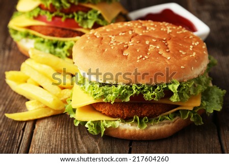 Big burger on brown wooden background