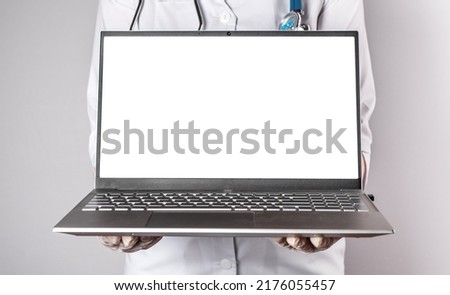 Doctor holding laptop mockup. Online medicine, distant medical consultation to patient, using computer at work and elearning, telehealth concept. High quality photo