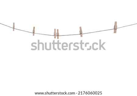 Six wood clothes pegs patterns hanging on brown string isolated on white background , clipping path