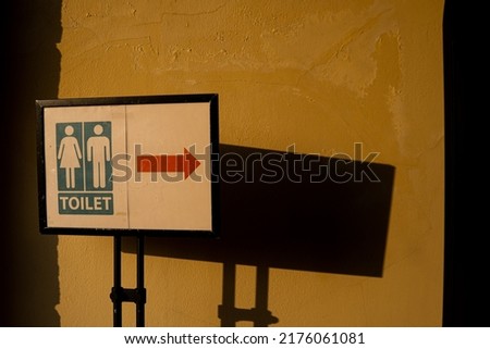 Female and male on restroom sign